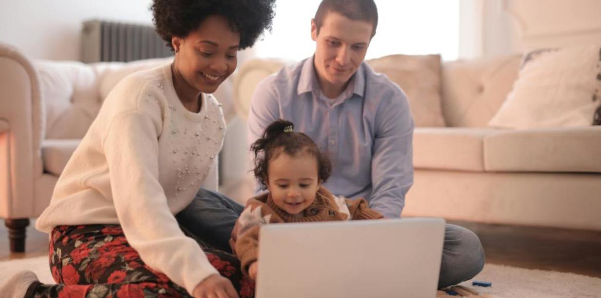 mom and dad with toddler using computer