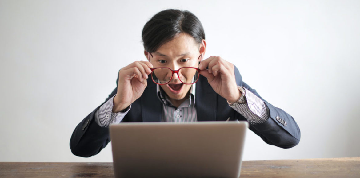 Man excited about what he sees on his computer
