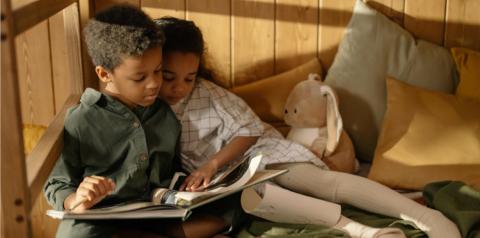 kids reading a book together